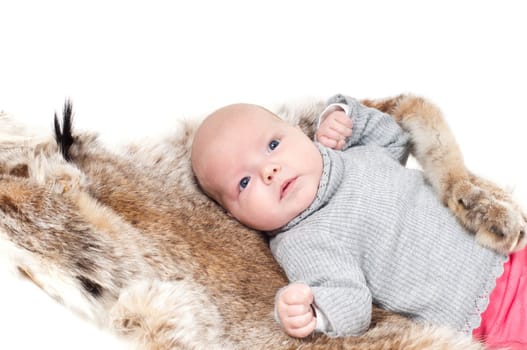 Shot of little cute baby in lying on fur