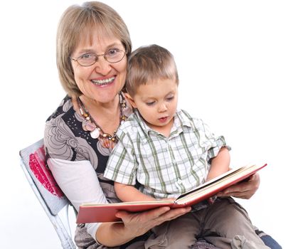 Grandmother and grandson reading a book together. Symbol of the family.