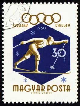 HUNGARY - CIRCA 1960: A post stamp printed in HUNGARY - CIRCA 1960: A post stamp printed in Hungary shows running skier, dedicated to the 8th Olympic Winter Games in Squaw Valley, series, circa 1960