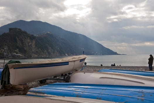 fishing boats on the beach in winter sunshine in the clouds
