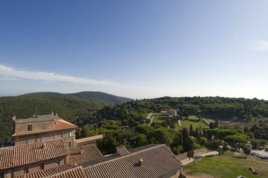 ancient village in Tuscany with archaeological park in the background