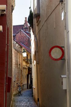 Bicycle on narrow Bruges streets behind the No traffic sign, Belgium. Europe