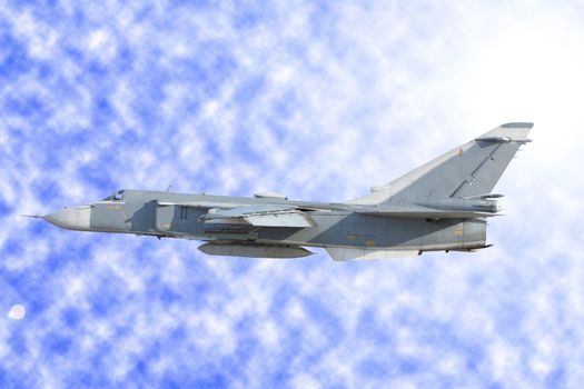 Military jet bomber Su-24 against clouds