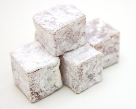 Turkish delight (lokum) confection on a white background