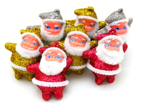Some dolls of Santa Claus are together isolated on a white background