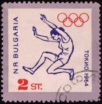 BULGARIA - CIRCA 1964: A post stamp printed in Bulgaria shows broad jump, devoted to Olympic games in Tokio, series, circa 1964