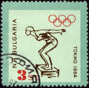 BULGARIA - CIRCA 1964: A post stamp printed in Bulgaria shows jumping swimmer, devoted to Olympic games in Tokio, series, circa 1964