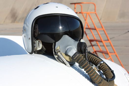 Protective helmet of the pilot against the plane with an oxygen mask on a fuel tank