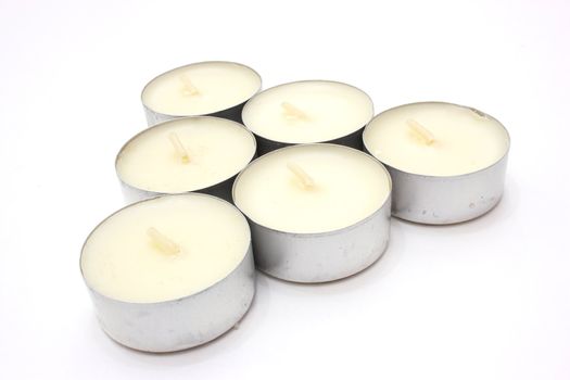 Candle floating aromatic in the metal case of white color on a white background