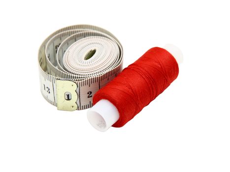 The coil of a red thread with centimeter on a white background