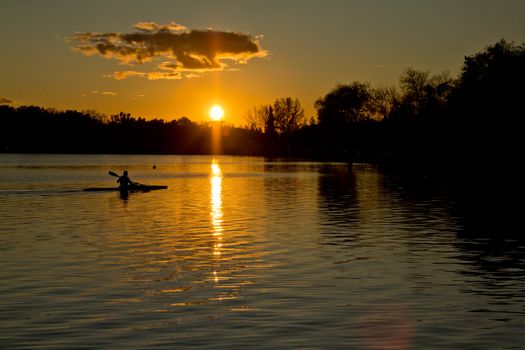 Beautiful sunset over lake Wascana with reflection of the sun on the water