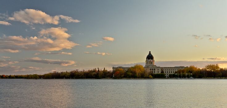 The Saskatchewan Legistlative building in the background with Wascanain the foreground right around sunset