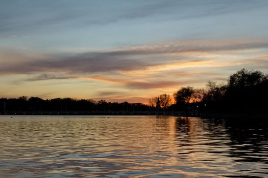 Beautiful sunset over lake Wascana with reflection of the sun on the water