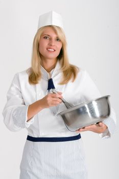 Female baker with a bowl and whisk to stir the dough