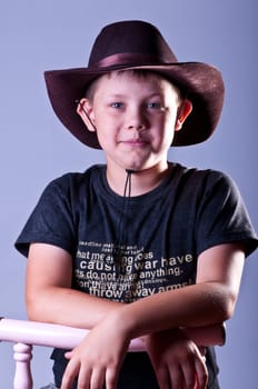 Young boy. Portrait in studio on a grey background.