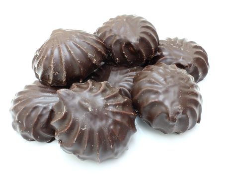 Marshmallow of black color lies on a white background