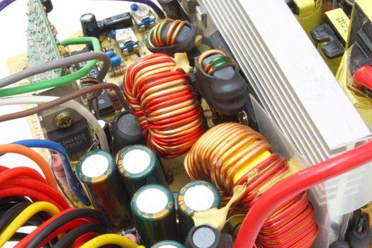 The computer power unit in an open kind with details and electric wires