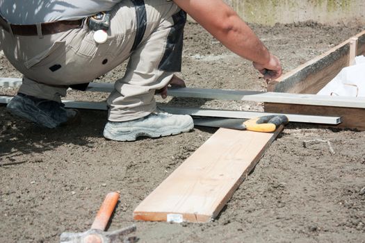 Mason preparing formwork in wood to build a terrace