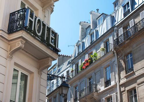 Sign of hotel and typical parisian buildings