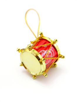 red toy as drum against the white background