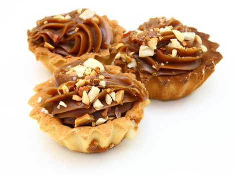 Pie a basket with chocolate condensed milk and nuts on a white background