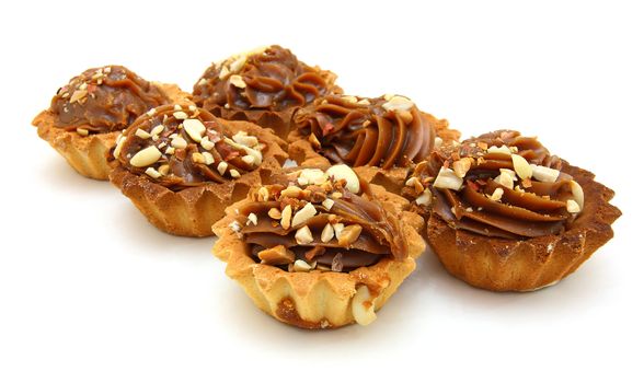 Pie a basket with chocolate condensed milk and nuts on a white background