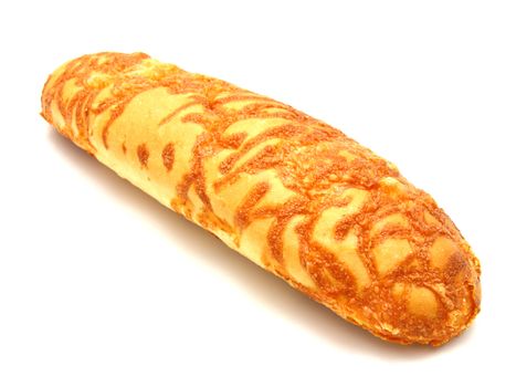 The ruddy long loaf of bread is strewed by cheese isolated on a white background