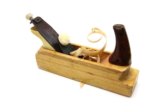Wooden plane, boards and a shaving on a white background
