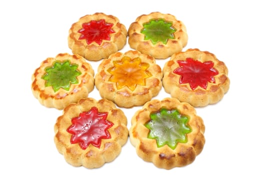 Cookies of yellow color with a stuffing from multi-colored jelly in the middle on a white background