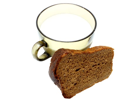 Black bread with milk in a mug on the white isolated background