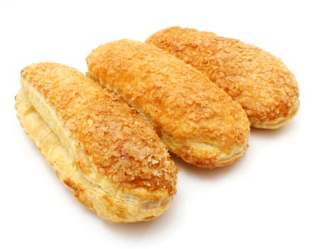 White roll strewed by sugar with a ruddy crust on a white background