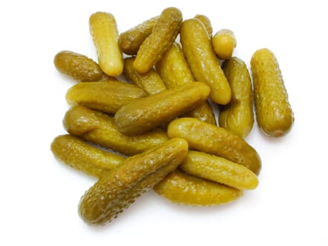 Green tasty pickles lie on a white background a small group