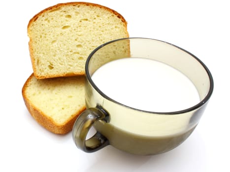 Black bread with milk in a mug on the white isolated background
