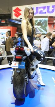 Looking at Suzuki motorcycles in exhibition at EICMA, International Motorcycle Exhibition in Milan, Italy.