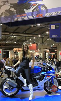 Looking at Suzuki motorcycles in exhibition at EICMA, International Motorcycle Exhibition in Milan, Italy.