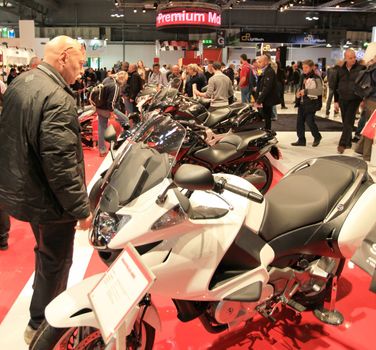 People trough Honda motorcycles exhibition area at EICMA, International Motorcycle Exhibition in Milan, Italy.