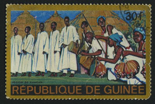 GUINEA - CIRCA 1984: stamp printed by Guinea, shows people in traditional suits, circa 1984.