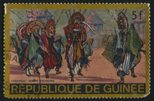 GUINEA - CIRCA 1984: stamp printed by Guinea, shows people in traditional suits, circa 1984.