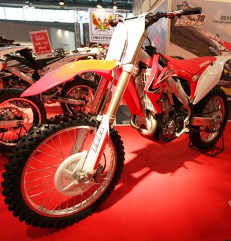 Looking at products and brand new motorcycles during EICMA, International Motorcycle Exhibition in Milan, Italy.