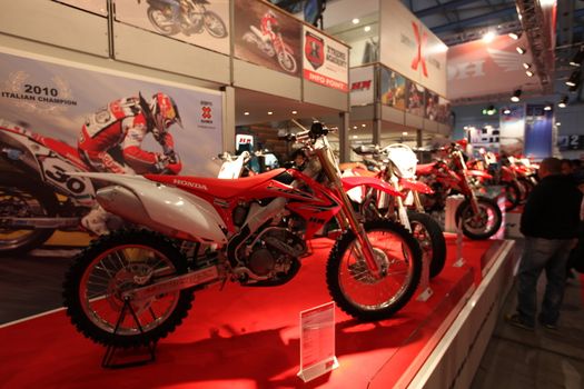 Looking at products and brand new motorcycles during EICMA, International Motorcycle Exhibition in Milan, Italy.