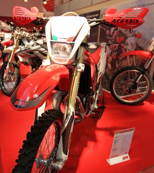 Looking at products and brand new motorcycles during EICMA, International Motorcycle Exhibition in Milan, Italy.