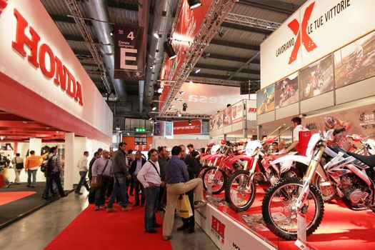 Looking at products and brand new motorcycles during EICMA, International Motorcycle Exhibition in Milan, Italy.