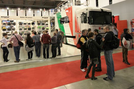 Looking at products and brand new motorcycles during EICMA, International Motorcycle Exhibition in Milan, Italy.