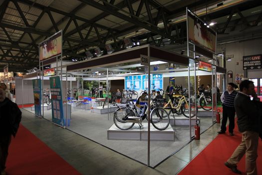 Looking at products and brand new motorcycles during EICMA, International Motorcycle Exhibition in Milan, Italy.