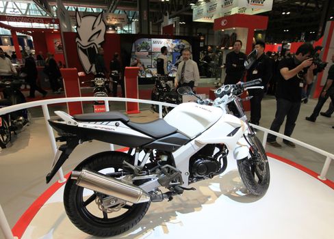 Looking at products and brand new motorcycles during EICMA, International Motorcycle Exhibition in Milan, Italy.