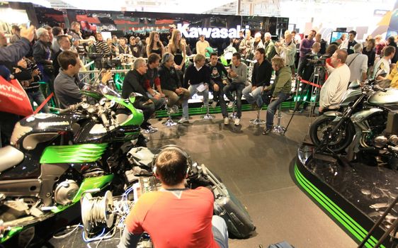 Kawasaki brand new products  area visited by people crowd at EICMA, International Motorcycle Exhibition in Milan, Italy.