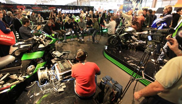 Kawasaki brand new products  area visited by people crowd at EICMA, International Motorcycle Exhibition in Milan, Italy.