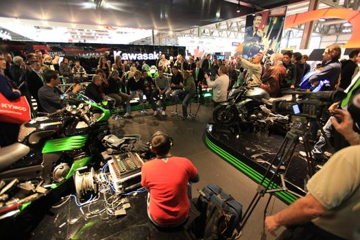 Kawasaki brand new products  area visited by people crowd at EICMA, International Motorcycle Exhibition in Milan, Italy.