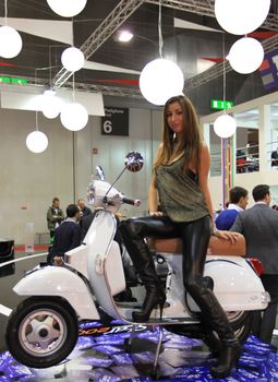 Walking trough scooters exhibition area at EICMA, International Motorcycle Exhibition in Milan, Italy.