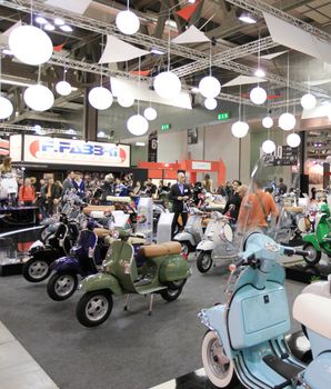 Walking trough scooters exhibition area at EICMA, International Motorcycle Exhibition in Milan, Italy.